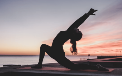 woman in a yoga pose in sunrise