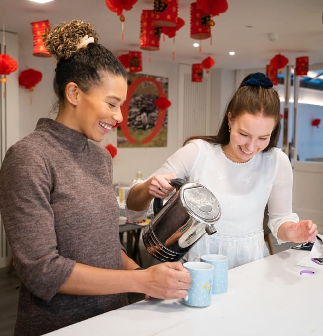 Two women making tea together