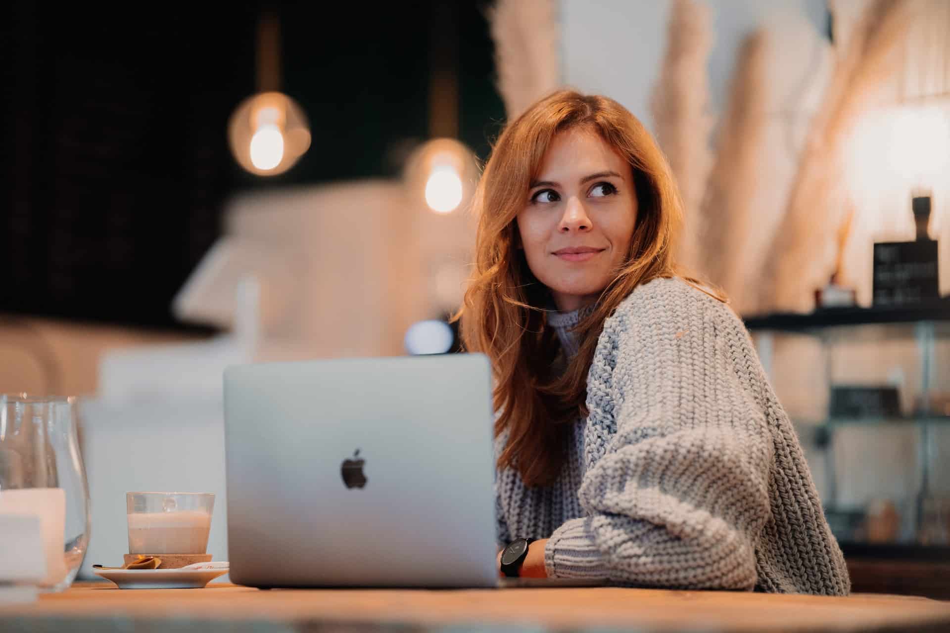 Woman sitting with laptop working