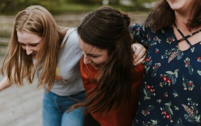 Three women linking arms symbolising sticking together and how to support someone with an eating disorder.