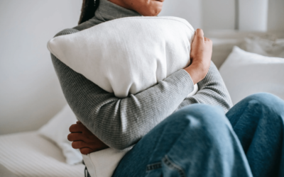 woman clutching pillow into her chest