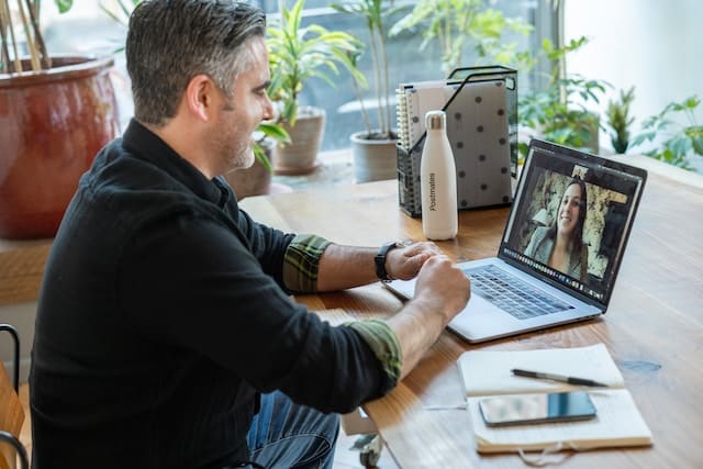 Man hosting consultation online with a woman
