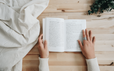 a pair of women hands on an open book