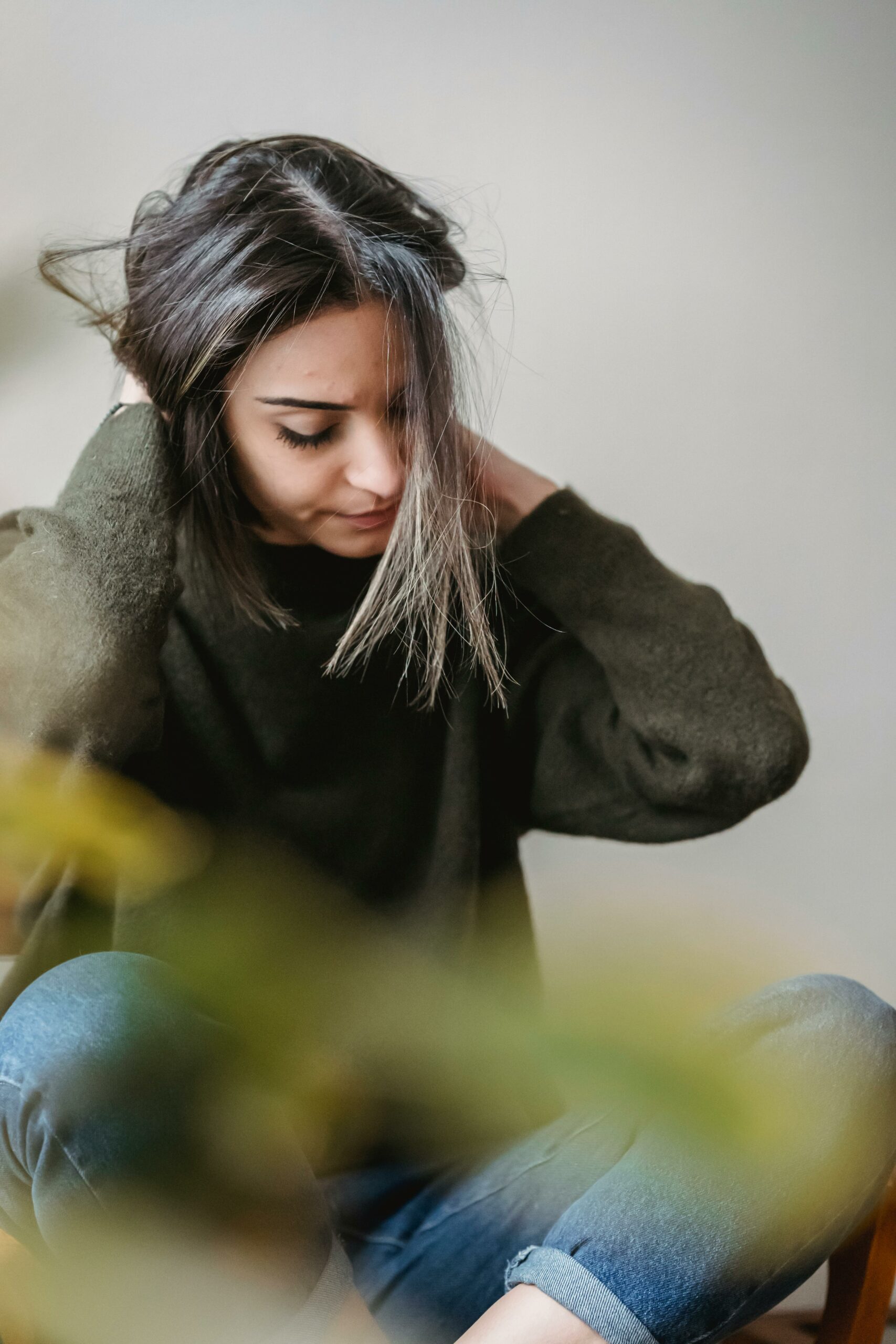Woman sitting cross-legged feeling stressed