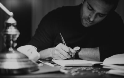 Man writing his thoughts down at a desk