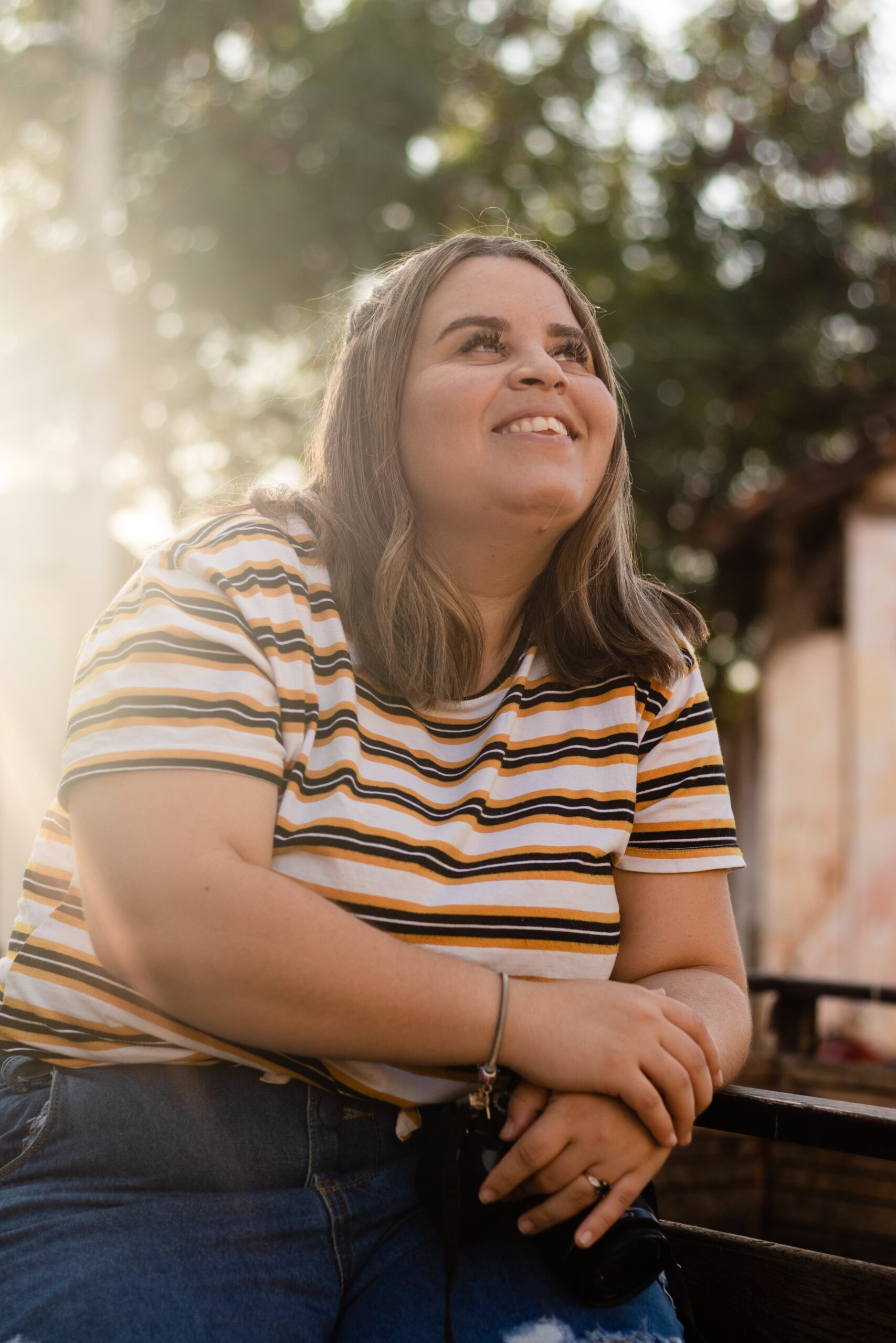 Woman sitting on the bed at her laptop