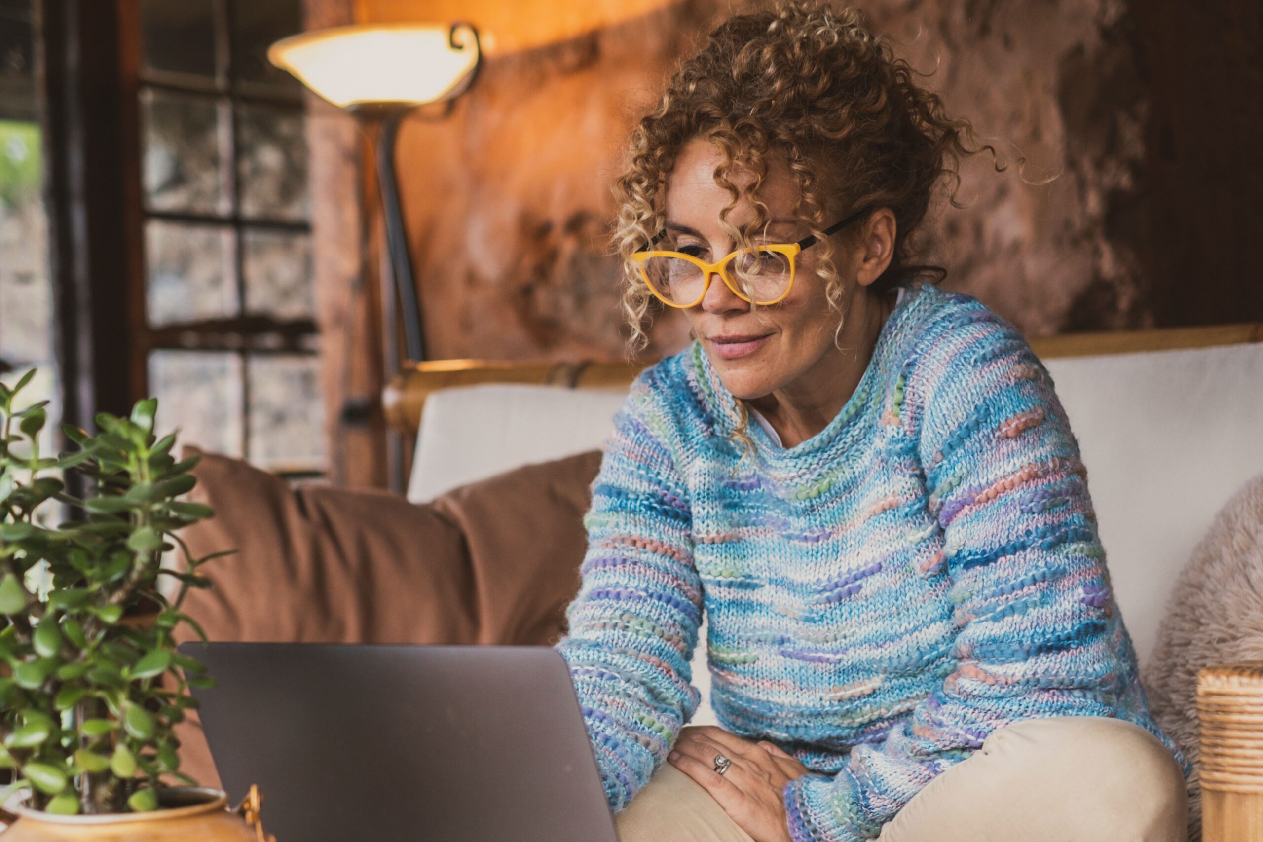 Older woman reading at a laptop