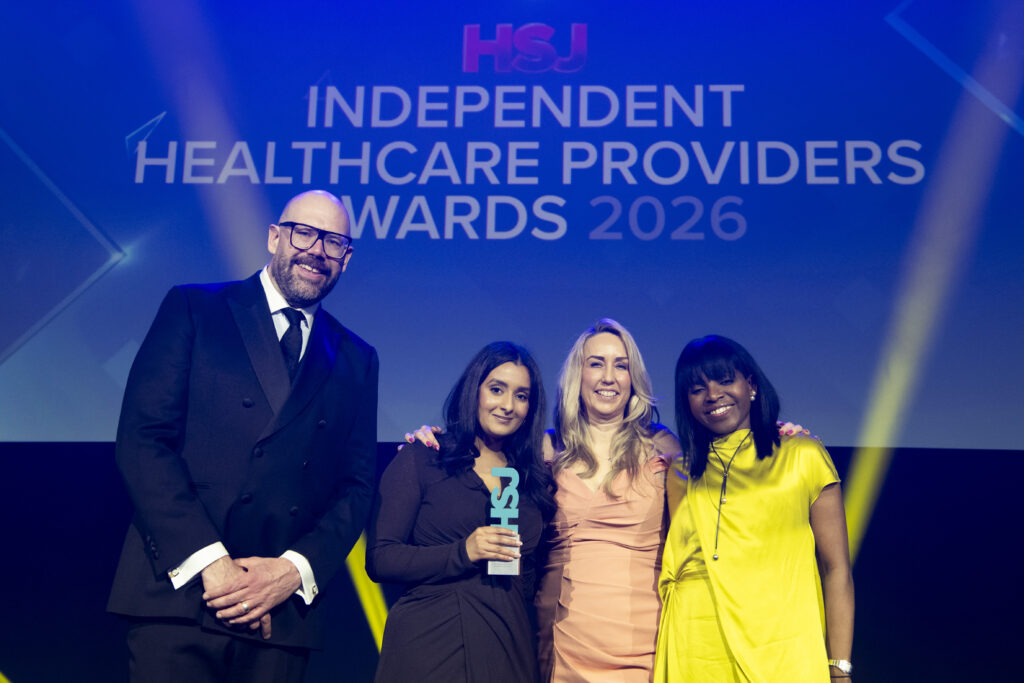 21_orri-nhs-sussex-and-nhs-kent-medway | Orri Group of award winners posing on stage at the Independent Healthcare Providers Awards 2026, with a blue backdrop.