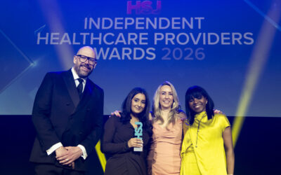 21_orri-nhs-sussex-and-nhs-kent-medway | Orri Group of award winners posing on stage at the Independent Healthcare Providers Awards 2026, with a blue backdrop.